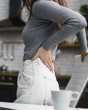 side-view-woman-having-backache-while-working-from-home