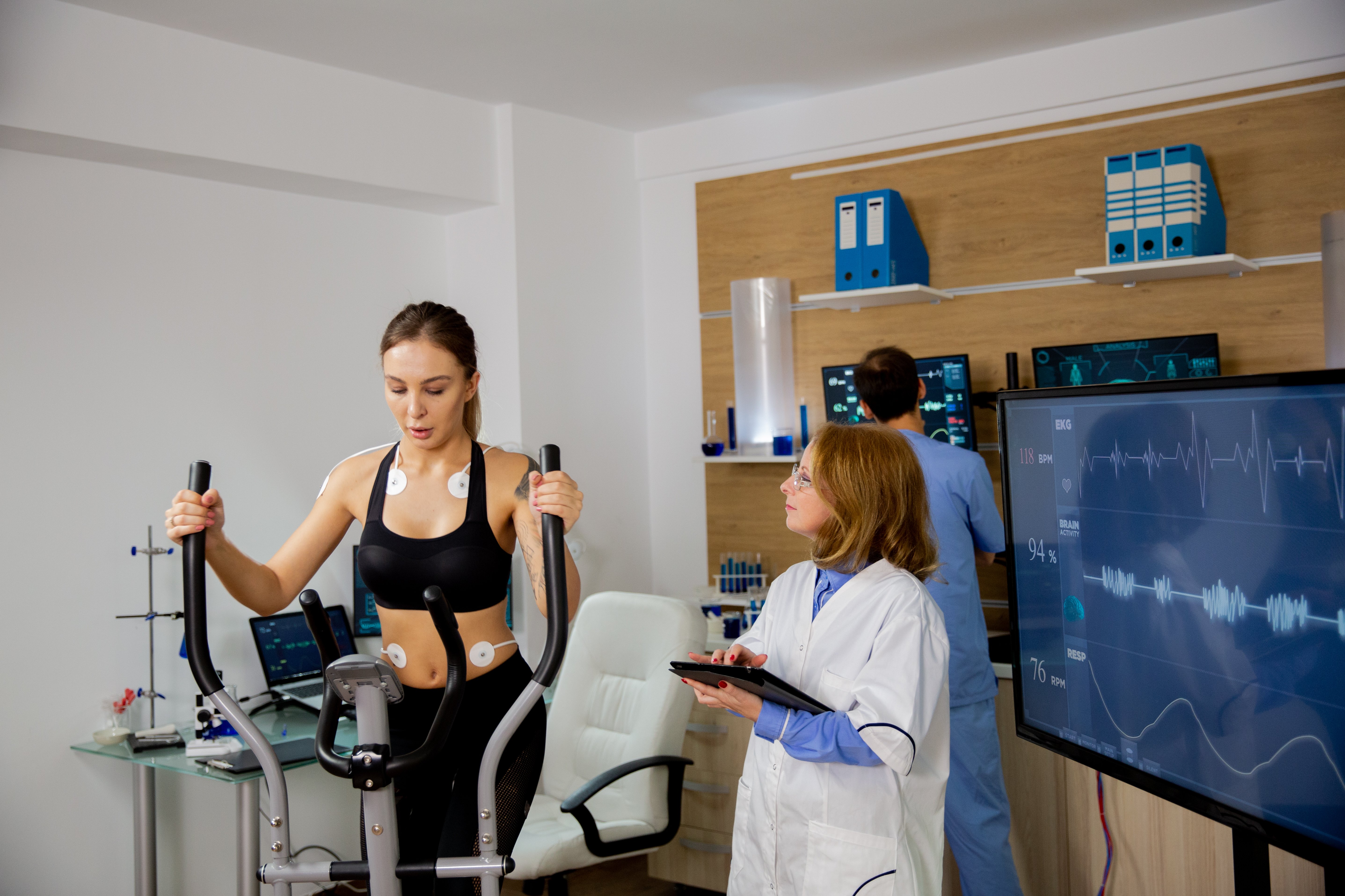 female-athlete-doing-physical-effort-stepper-doctor-follows-her-sports-laboratory